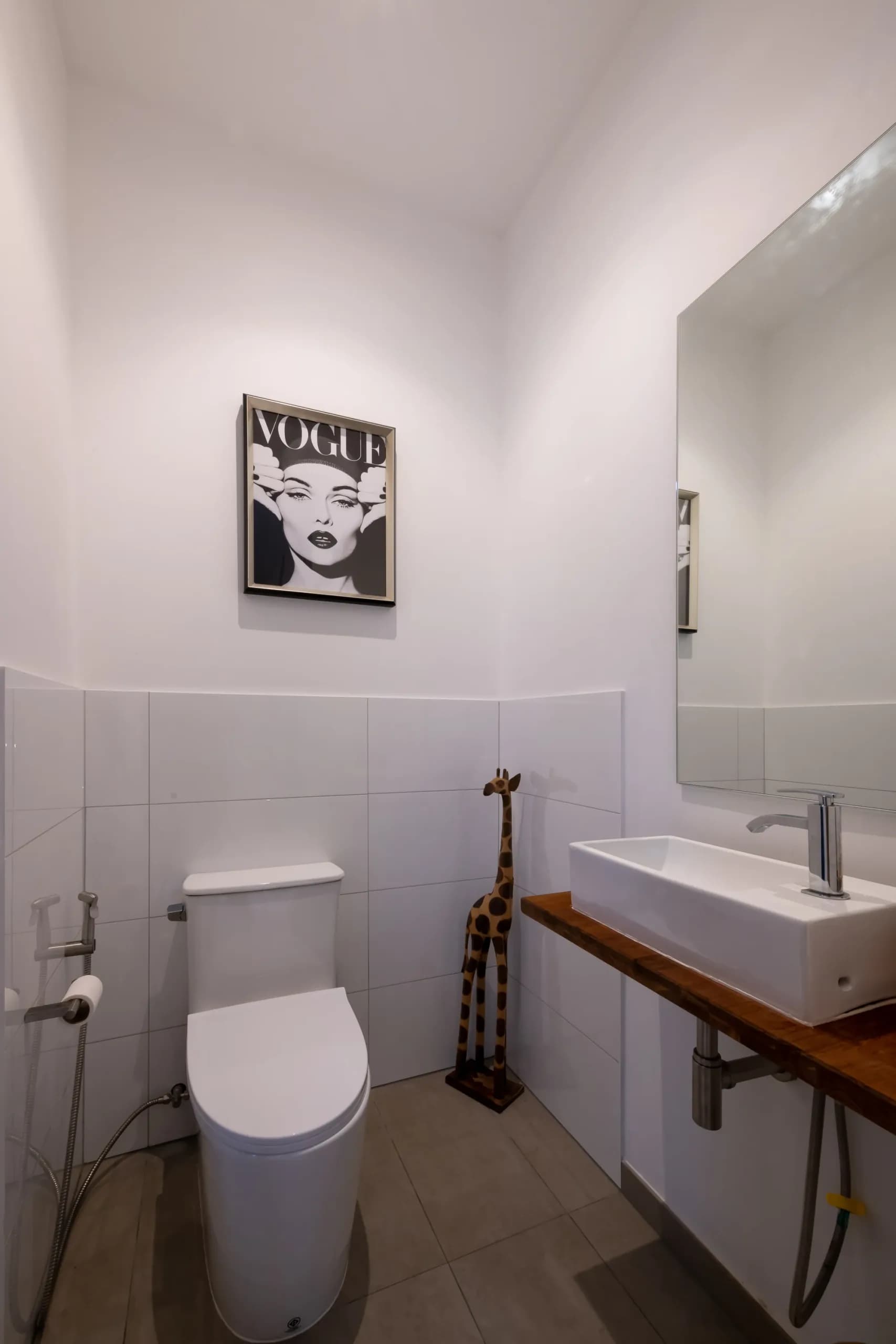 Powder room with monochrome Vogue print and timber vanity